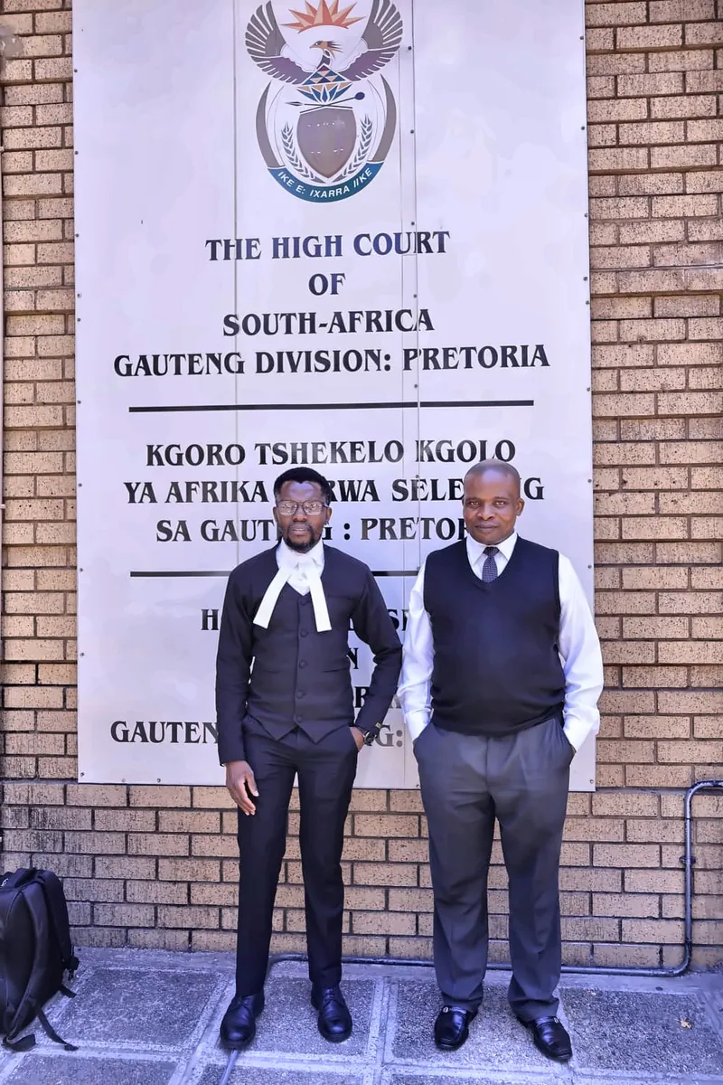 Two legal professionals standing near the High Court Gauteng Division sign