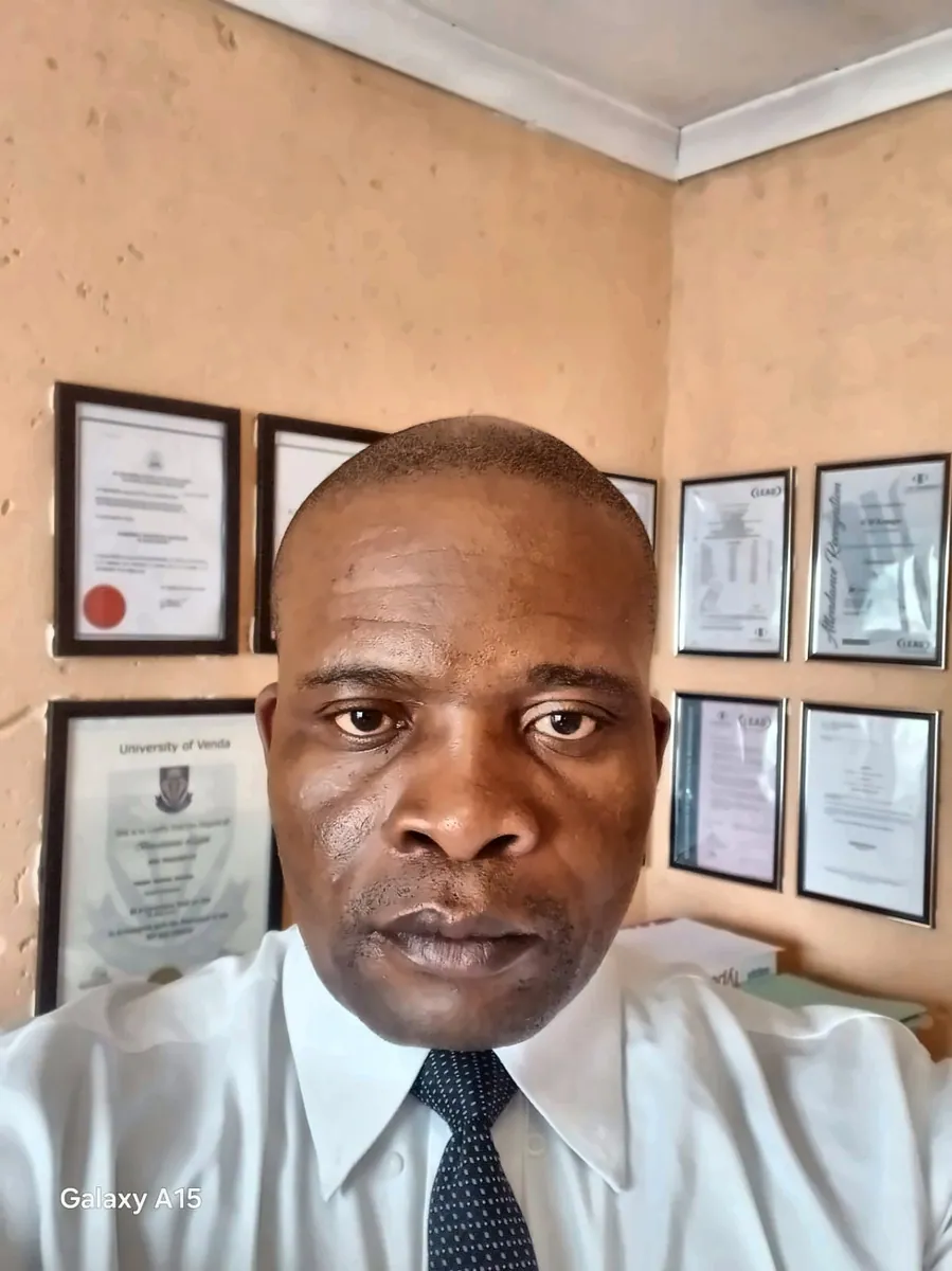 Professional portrait in an office with certificates on the wall